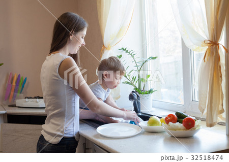 kitchen mom son wash fruits and vegetables kitchen mom son wash fruits and vegetables 32518474