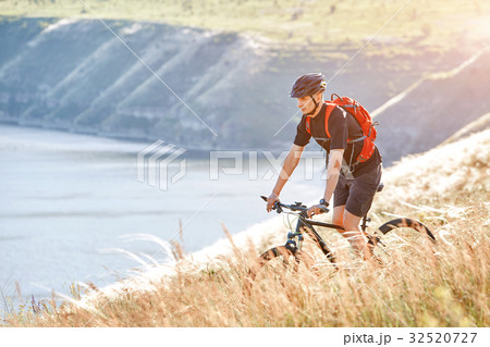 Attractive cyclist rirding mountain bike above 32520727