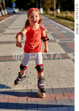 Girl riding on roller skates in skatepark summer Girl riding on roller skates in skatepark summer 32521175
