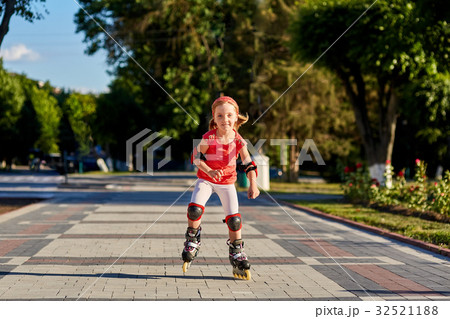 Girl riding on roller skates in skatepark summer Girl riding on roller skates in skatepark summer 32521188