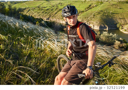 Mountain bike adventur. Cyclist has a rest on Mountain bike adventur. Cyclist has a rest on 32521199