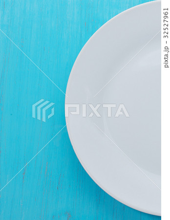 white plate on old blue wooden background. white plate on old blue wooden background. 32527961