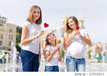 Samesex lesbian family with child on a walk in the 32532611