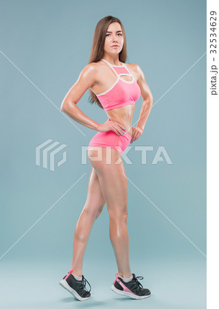 Muscular young woman athlete posing at studio Muscular young woman athlete posing at studio 32534629