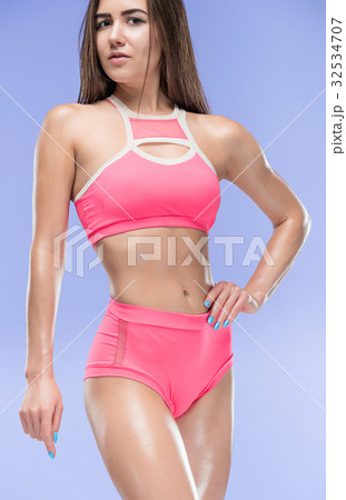Muscular young woman athlete posing at studio Muscular young woman athlete posing at studio 32534707