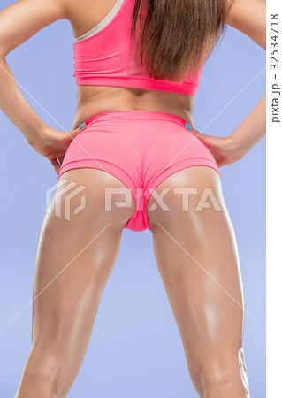 Muscular young woman athlete posing at studio 32534718