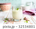Garlic sauce in a glass with garlic gloves Garlic sauce in a glass with garlic gloves 32534801