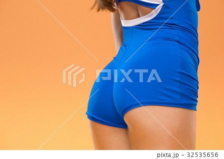 Muscular young woman athlete posing at studio 32535656