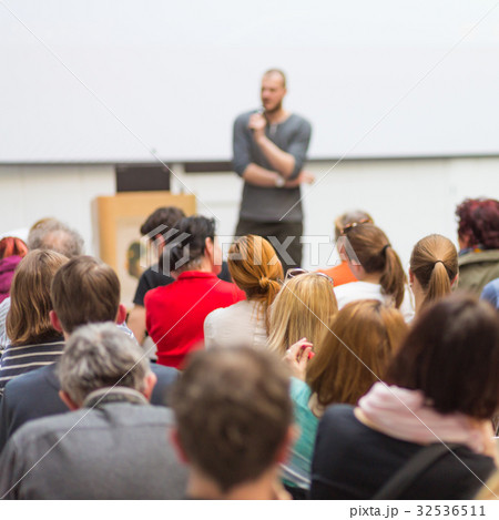 Man giving presentation in lecture hall at 32536511