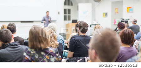Man giving presentation in lecture hall at 32536513