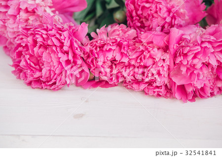 Bouquet of pink peonies on a wooden table. 32541841