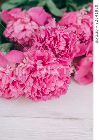 Bouquet of pink peonies on a wooden table Bouquet of pink peonies on a wooden table 32541950