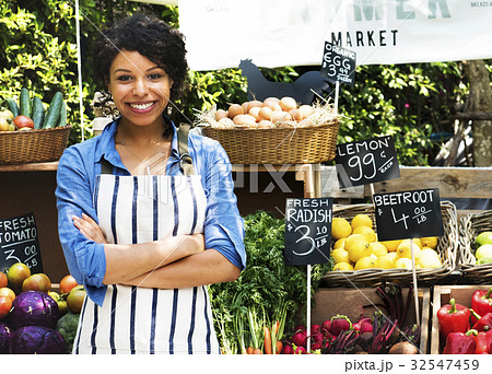 Woman Selling Fresh Local Vegetable at Farmers Market Woman Selling Fresh Local Vegetable at Farmers Market 32547459