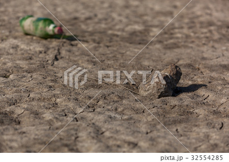 A plastic bottle is tied by a rope to the stone A plastic bottle is tied by a rope to the stone 32554285