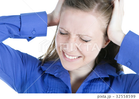 woman with headache holding her hands to the head 32558599