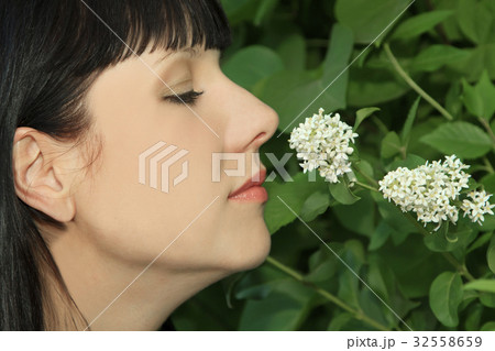 Young Woman Enjoying Smelling aroma Flowers Young Woman Enjoying Smelling aroma Flowers 32558659
