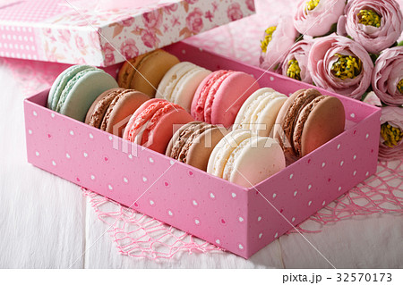 Festive macaroons in a gift box and flowers Festive macaroons in a gift box and flowers 32570173