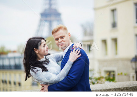 Romantic couple in Paris near the Eiffel tower Romantic couple in Paris near the Eiffel tower 32571449