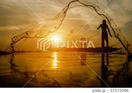 silhouette fisherman with sunset sky on the lake. silhouette fisherman with sunset sky on the lake. 32572096