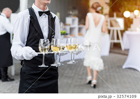 Midsection of professional waiter in uniform Midsection of professional waiter in uniform 32574109