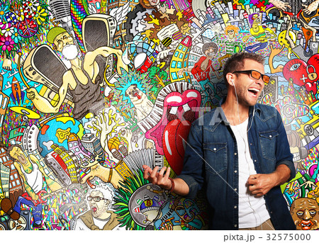 Guy listening to music and simulates play guitar 32575000