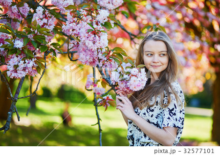 Beautiful young woman in blooming spring park Beautiful young woman in blooming spring park 32577101