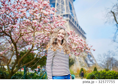 Girl in Paris near the Eiffel tower and pink magnolia Girl in Paris near the Eiffel tower and pink magnolia 32577755