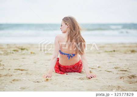 Beautiful young woman in bikini and red pareo 32577829