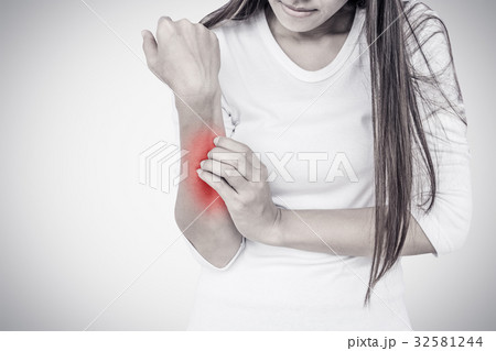 Woman scratching her elbow. Woman scratching her elbow. 32581244