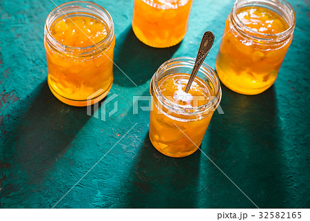 Four jars of pineapple jam on a turquoise table Four jars of pineapple jam on a turquoise table 32582165