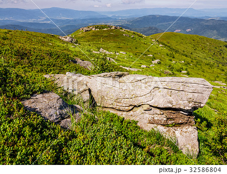 huge boulders on the edge of hillside 32586804