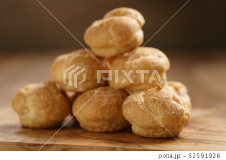 profiteroles on olive board closeup profiteroles on olive board closeup 32591926