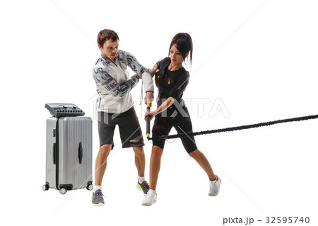 Woman in EMS suit doing lunge exercise Woman in EMS suit doing lunge exercise 32595740