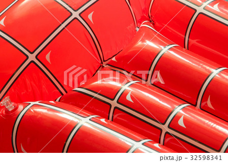 Red inflatable floating mattress as background. Red inflatable floating mattress as background. 32598341