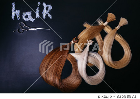 hair extensions of three colors on a dark 32598973