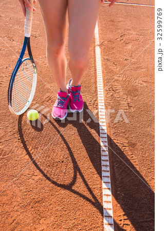 Female legs with tennis racket 32599769