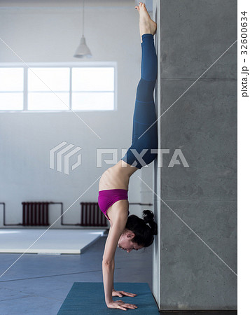 Yoga girl doing handstand with backbend exercise 32600634
