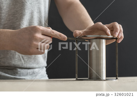 Man with cylindrical metal construction 32601021