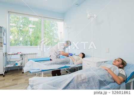 Nurse connecting an intravenous drip in hospital Nurse connecting an intravenous drip in hospital 32601861
