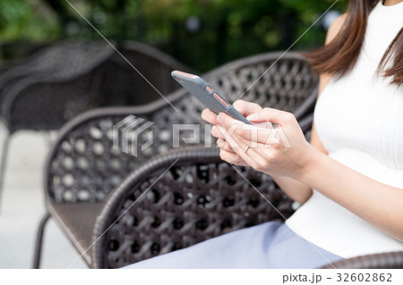 Woman using mobile phone at outdoor restaurant 32602862