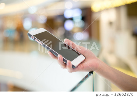 Woman holding on cellphone Woman holding on cellphone 32602870