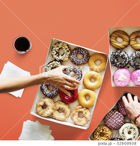 Group of hands holding sweeten donut dessert Group of hands holding sweeten donut dessert 32609938