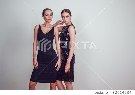 Two beautiful women in black night fashion dress Two beautiful women in black night fashion dress 32614234