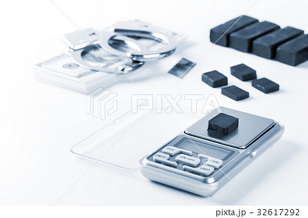 Blocks of hashish on digital scales over white 32617292