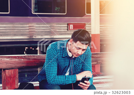 Handsome young asian man looking smart phone 32623003