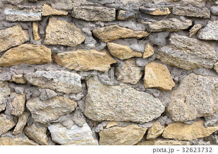 Stone wall from limestone stones. Abstract texture 32623732