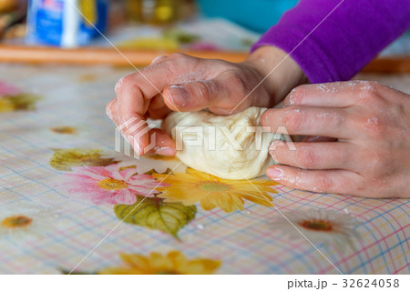 Woman hands kneading dough on the table Woman hands kneading dough on the table 32624058