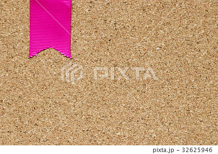 Pink ribbon placed on cork board background 32625946