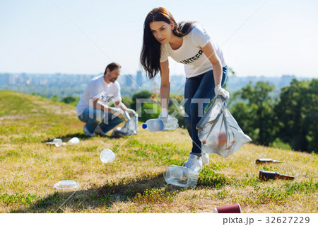 Active admirable woman cleaning the lawn Active admirable woman cleaning the lawn 32627229