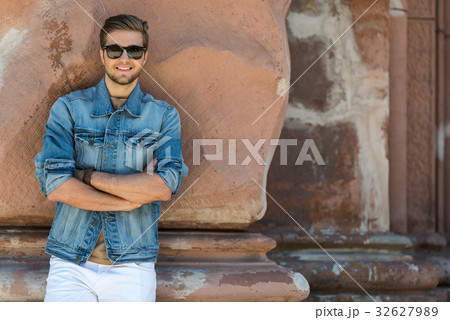 Cheerful youthful male spending time sightseeing Cheerful youthful male spending time sightseeing 32627989